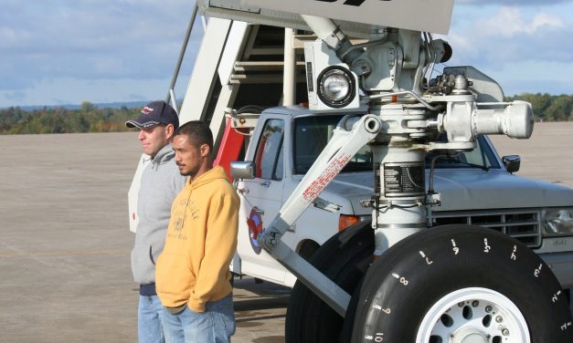 A couple of rather serious faced coworkers standing in front of our B747SP’s nose landing gear for a photo op.