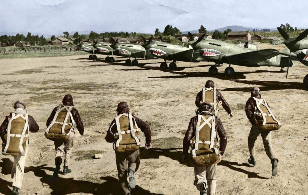 A colourised photo of pilots of the American Volunteer Group (AVG aka The Flying Tigers) running to their P-40…