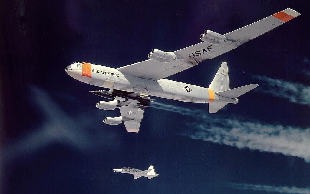 X-15 being carried by its NB-52B mothership (52-0008), with T-38A chase plane.