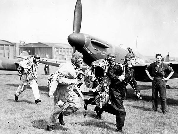 Pilots of 19 Squadron scramble in front of the press at Duxford, March 1939.