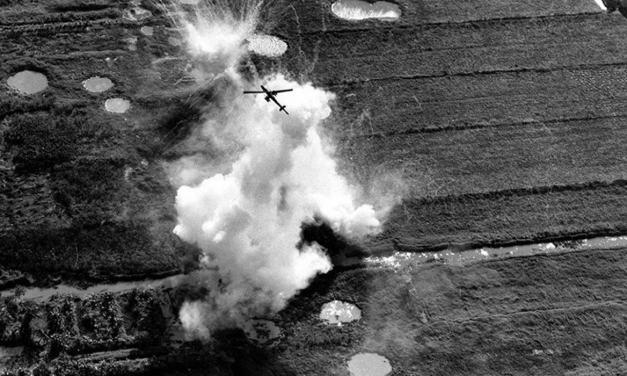A Bell UH-1E Cobra pulling out of a rocket and strafing run on a Viet Cong position near Cao Lanh in the Mekong…