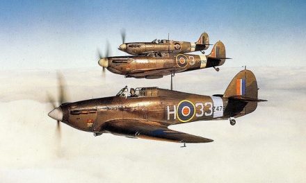 A colour photograph of a Hurricane Mk.I and a pair of Spitfire Mk.IIs of the Empire Central Flying School in…