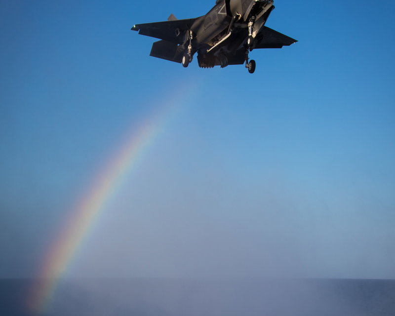 Trailing a rainbow an F-35B Lightning II about to land aboard the Royal Navy aircraft carrier HMS Queen Elizabeth…